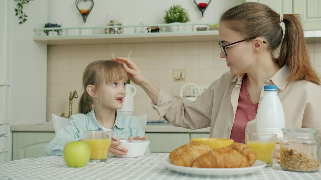 Danish family sitting together at home sharing a story over coffee